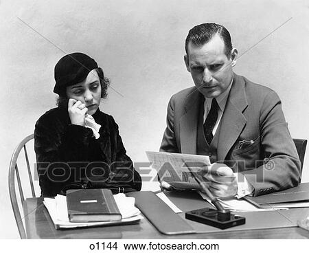 Picture - 1930 1930S Woman Crying With Tissue Man Sitting At Desk. Fotosearch