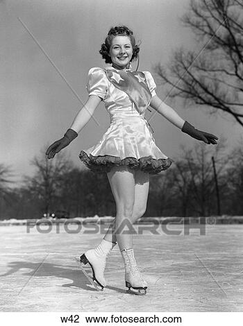 Stock Image - 1930 1930S Woman Figure Skater On Ice Wearing Dress And Gloves . Fotosearch