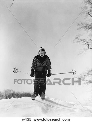 Stock Photography - 1930 1930S Woman Holding Ski Poles Skiing In Snow. Fotosearch