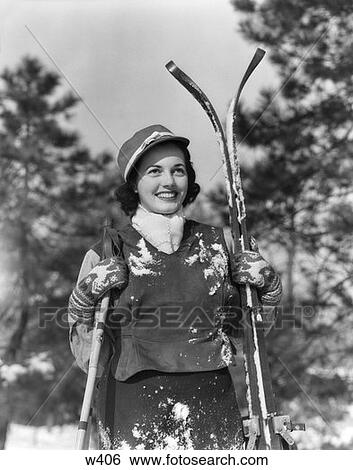 Stock Photograph - 1930 1930S Woman Holding Skis Outside Covered In Snow. Fotosearch
