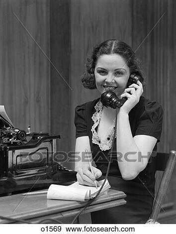 1930 1930S Woman Sitting At Desk In Office Talking On Telephone View Large Photo Image Stock Photo - 1930 1930S Woman Sitting At Desk In Office Talking On Telephone . Fotosearch