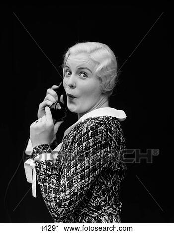 Stock Image - 1930 1930S Woman Talking On Telephone Surprised Expression On Face . Fotosearch
