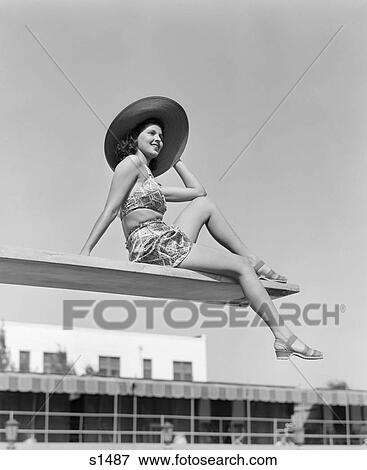 1930 1930S Woman Wearing Hat Sitting Near Edge Of Diving Board View Large Photo Image Stock Photo - 1930 1930S Woman Wearing Hat Sitting Near Edge Of Diving Board . Fotosearch