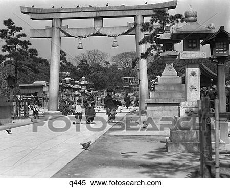 Stock Photography - 1930 1930S Women Children Walking Under Torii Arch At Minatogawa Shinto Shrine Religion Gateway Kobe Japan Rrr Retro . Fotosearch