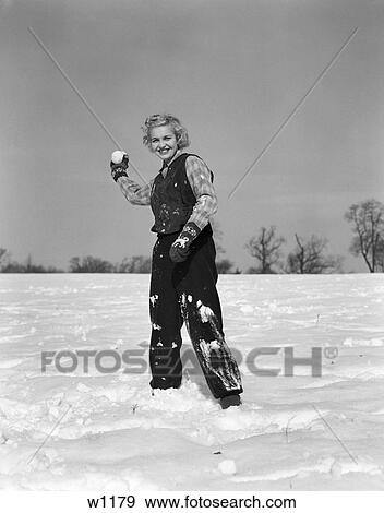 1930 1930S Young Girl Playing In Snow About To Throw Snowball View Large Photo Image Stock Photo - 1930 1930S Young Girl Playing In Snow About To Throw Snowball . Fotosearch
