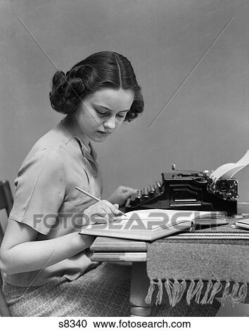 1930 1930S Young Woman Sitting At Desk With Typewriter And Book Studying View Large Photo Image Stock Image - 1930 1930S Young Woman Sitting At Desk With Typewriter And Book Studying . Fotosearch