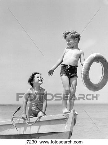 1930S 1930 Boy Standing Bow Row Boat Holding Life Preserver Girl Hold Anchor Summer Shore Playing Fun Retro View Large Photo Image Stock Image - 1930S 1930 Boy Standing Bow Row Boat Holding Life Preserver Girl Hold Anchor Summer Shore Playing Fun Retro . Fotosearch
