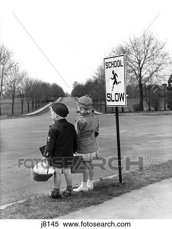 1930S 1940S Boy Girl Waiting To Cross Street By School Slow Sign View Large Photo Image Stock Photography - 1930S 1940S Boy Girl Waiting To Cross Street By School Slow Sign . Fotosearch