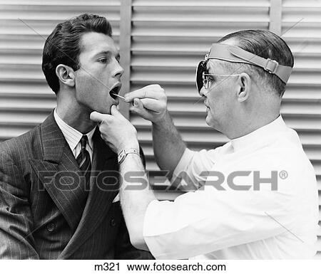 1930S 1940S Doctor Examining Throat Of Young Man Patient View Large Photo Image Stock Image - 1930S 1940S Doctor Examining Throat Of Young Man Patient . Fotosearch