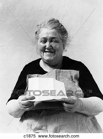 1930S 1940S Elderly Character Woman Smiling Reading Letter Wearing Apron View Large Photo Image Stock Photography - 1930S 1940S Elderly Character Woman Smiling Reading Letter Wearing Apron . Fotosearch