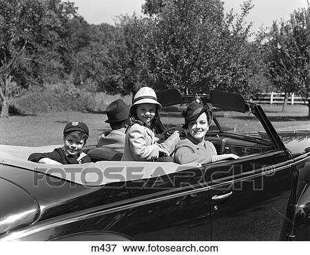 1930S 1940S Family Of 4 In Convertible Car Father Driving Mother Daughter Son Are Turned Looking At Camera Smiling View Large Photo Image Stock Photo - 1930S 1940S Family Of 4 In Convertible Car Father Driving Mother Daughter Son Are Turned Looking At Camera Smiling . Fotosearch