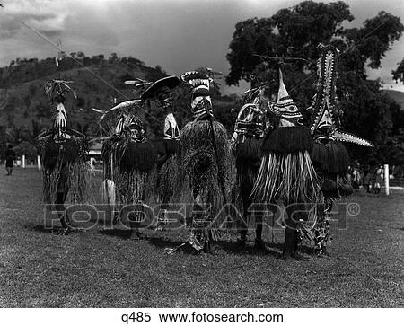 1930S 1940S Group Of Natives In Elaborate Straw Ceremonial Costumes Devil Chasers Port Moresby New Guinea View Large Photo Image Stock Photography - 1930S 1940S Group Of Natives In Elaborate Straw Ceremonial Costumes Devil Chasers Port Moresby New Guinea. Fotosearch