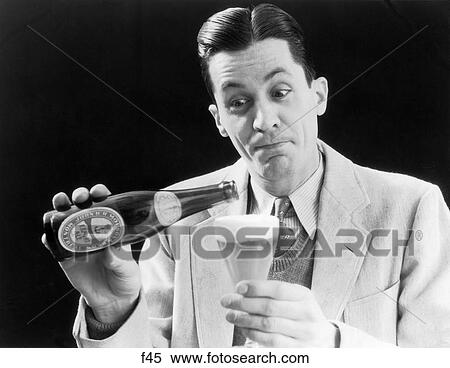 1930S 1940S Man Pouring Beer From Bottle Into Glass Look Of Anticipation Thirst Molson'S Man Wearing Suit Tie Sweater Export Ale View Large Photo Image Stock Photography - 1930S 1940S Man Pouring Beer From Bottle Into Glass Look Of Anticipation Thirst Molson'S Man Wearing Suit Tie Sweater Export Ale. Fotosearch