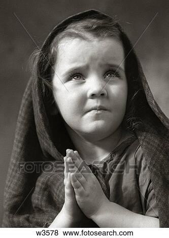 1930S 1940S Sad Little Girl Shawl Over Hair Hands Praying View Large Photo Image Stock Photo - 1930S 1940S Sad Little Girl Shawl Over Hair Hands Praying. Fotosearch