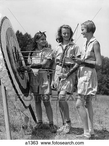 1930S 1940S Three Teen Girls Standing By Archery Target Bows Arrows View Large Photo Image Stock Image - 1930S 1940S Three Teen Girls Standing By Archery Target Bows Arrows . Fotosearch