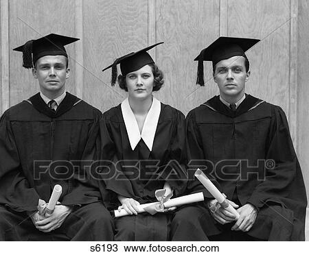 Stock Image - 1930S 1940S Three University Students Cap Gown Graduation Robes 2 Men Woman Students Holding Diplomas Retro . Fotosearch