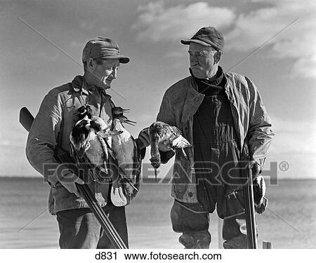 1930S 1940S Two Men Duck Hunters Holding Shotguns Holding Captured Ducks View Large Photo Image Stock Image - 1930S 1940S Two Men Duck Hunters Holding Shotguns Holding Captured Ducks . Fotosearch