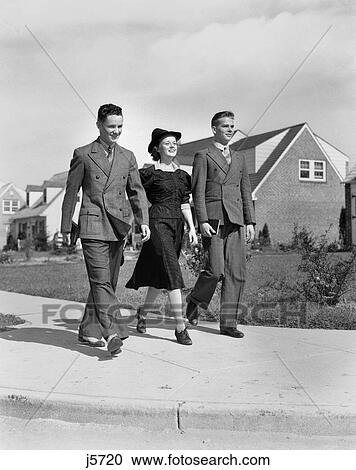 1930S 1940S Two Teen Boys One Girl Dressed Up Walking Down Suburban Sidewalk View Large Photo Image Stock Image - 1930S 1940S Two Teen Boys One Girl Dressed Up Walking Down Suburban Sidewalk . Fotosearch