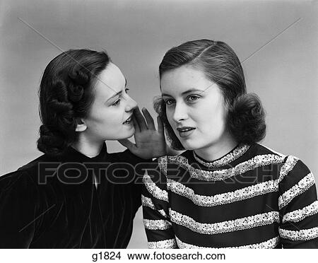 Picture - 1930S 1940S Two Women Head And Shoulders Woman In Dark Blouse Is Whispering Into The Ear Of Woman In Striped Top Gossip . Fotosearch