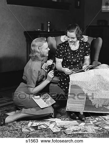 1930S 1940S Two Women Reading Maps And Travel Brochures Smiling Planning Vacation Travel Chair View Large Photo Image Stock Image - 1930S 1940S Two Women Reading Maps And Travel Brochures Smiling Planning Vacation Travel Chair . Fotosearch
