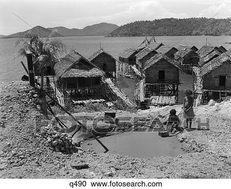1930S 1940S Water Hole Two Native Children Village Of Hanuabado Straw Grass Houses Huts On Stilts View Large Photo Image Stock Image - 1930S 1940S Water Hole Two Native Children Village Of Hanuabado Straw Grass Houses Huts On Stilts . Fotosearch