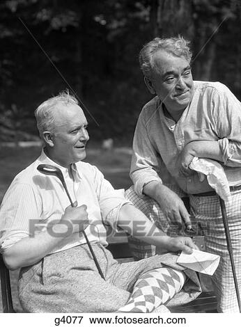 1930S 2 Elderly Men Smiling Wear Golf Clothes Knickers Argylle Socks Holding Golf Clubs And Score Sheet View Large Photo Image Stock Photo - 1930S 2 Elderly Men Smiling Wear Golf Clothes Knickers Argylle Socks Holding Golf Clubs And Score Sheet . Fotosearch