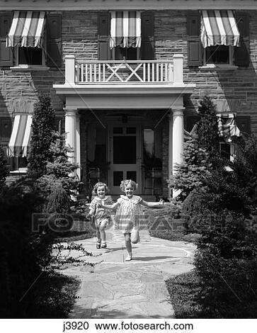 1930S 2 Girls In Summer Dresses Running To Camera On Flagstone Sidewalk In Front Of House View Large Photo Image Stock Image - 1930S 2 Girls In Summer Dresses Running To Camera On Flagstone Sidewalk In Front Of House . Fotosearch
