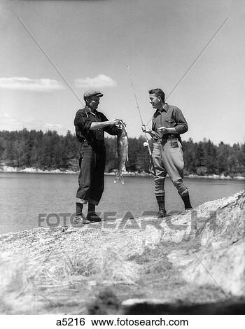 1930S 2 Men Fisherman Fishing Holding Up Days Catch Trout Lake Of The Woods Ontario Canada Adventure Male Bonding Retro View Large Photo Image Stock Photograph - 1930S 2 Men Fisherman Fishing Holding Up Days Catch Trout Lake Of The Woods Ontario Canada Adventure Male Bonding Retro. Fotosearch