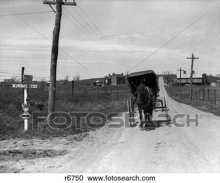 1930S Amish Man Driving Buggy Down Dirt Road With Farm In Background View Large Photo Image Stock Image - 1930S Amish Man Driving Buggy Down Dirt Road With Farm In Background . Fotosearch