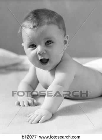 1930S Baby Lying On Stomach Propped Up On Hands With Mouth Open View Large Photo Image Stock Photo - 1930S Baby Lying On Stomach Propped Up On Hands With Mouth Open . Fotosearch