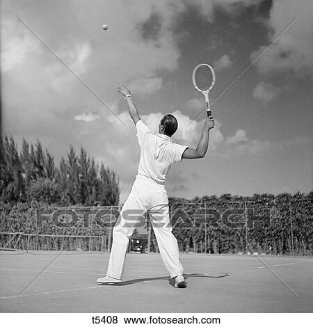 1930S Back View Of Man Playing Tennis About To Hit The Ball Summer Outdoor View Large Photo Image Stock Photo - 1930S Back View Of Man Playing Tennis About To Hit The Ball Summer Outdoor . Fotosearch