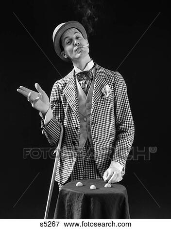 1930S Barker In Checkered Suit & Cigarette In Mouth Playing Shell Game View Large Photo Image Stock Photo - 1930S Barker In Checkered Suit & Cigarette In Mouth Playing Shell Game . Fotosearch