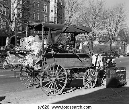 1930S Beat-Up Horse Cart Full Of Junk Parked Along Curb View Large Photo Image Stock Photograph - 1930S Beat-Up Horse Cart Full Of Junk Parked Along Curb . Fotosearch