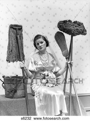 1930S Bride Seated Next To Bucket With Bouquet In Lap Holding Mops & Brooms & Looking Distressed View Large Photo Image Stock Image - 1930S Bride Seated Next To Bucket With Bouquet In Lap Holding Mops & Brooms & Looking Distressed . Fotosearch