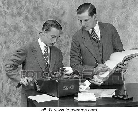 1930S Clerk And Young Assistant In Office Using Ledger Book & Adding Machine View Large Photo Image Stock Photo - 1930S Clerk And Young Assistant In Office Using Ledger Book & Adding Machine . Fotosearch