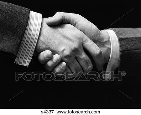 1930S Close-Up Of Businessmen'S Hands In Handshake Against Dark Background View Large Photo Image Stock Photo - 1930S Close-Up Of Businessmen'S Hands In Handshake Against Dark Background . Fotosearch