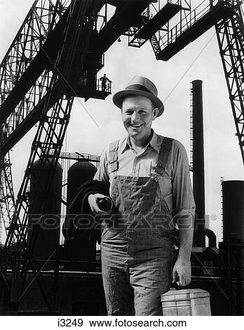 Stock Photo - 1930S Composite Of Worker In Front Of Factory . Fotosearch