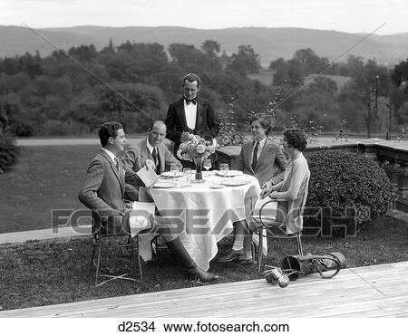 1930S Country Club Scene With 2 Couples With Golfclubs Having Lunch Outdoors View Large Photo Image Picture - 1930S Country Club Scene With 2 Couples With Golfclubs Having Lunch Outdoors . Fotosearch