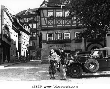 1930S Couple By Car Looking At Map In Front Of Eisenach Lutherhaus 1563 Where Luther Lived While Attending School Outdoor View Large Photo Image Stock Photo - 1930S Couple By Car Looking At Map In Front Of Eisenach Lutherhaus 1563 Where Luther Lived While Attending School Outdoor. Fotosearch