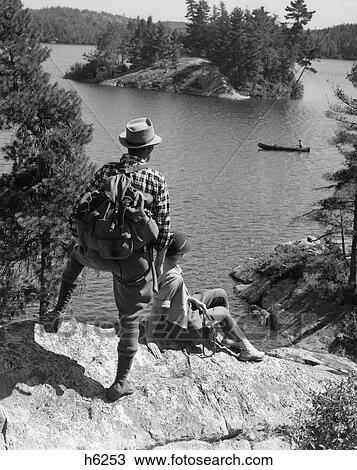 1930S Couple Hiking Together Looking At Canoe Lake Of The Woods Ontario Canada View Large Photo Image Stock Image - 1930S Couple Hiking Together Looking At Canoe Lake Of The Woods Ontario Canada. Fotosearch