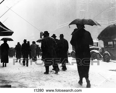 1930S Crowd Of Pedestrians In Snow Storm Walking On City Street Traffic Lights Umbrellas View Large Photo Image Stock Image - 1930S Crowd Of Pedestrians In Snow Storm Walking On City Street Traffic Lights Umbrellas. Fotosearch