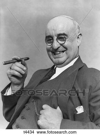 1930S Elderly Businessman In 3-Piece Suit & Glasses Leaning Back Smiling With Cigar In Hand View Large Photo Image Picture - 1930S Elderly Businessman In 3-Piece Suit & Glasses Leaning Back Smiling With Cigar In Hand . Fotosearch