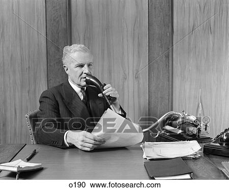1930S Elderly Male Executive Sitting At Desk Speaking Into Dictaphone View Large Photo Image Stock Image - 1930S Elderly Male Executive Sitting At Desk Speaking Into Dictaphone . Fotosearch