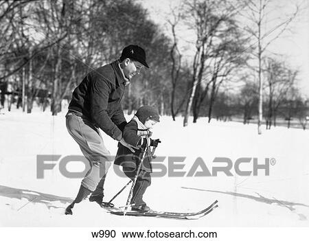 1930S Father Son Father Wearing Jacket Hat Son Wearing Snowsuit Father Teaching Son Ski Trees View Large Photo Image Stock Image - 1930S Father Son Father Wearing Jacket Hat Son Wearing Snowsuit Father Teaching Son Ski Trees . Fotosearch