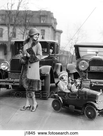 1930S Girl Looking Into Compack Sitting In Her Toy Car With Her Wire Terrier Mother Looking Watching View Large Photo Image Stock Photography - 1930S Girl Looking Into Compack Sitting In Her Toy Car With Her Wire Terrier Mother Looking Watching. Fotosearch