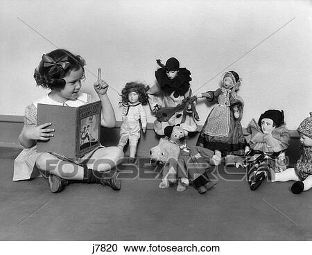 1930S Girl Pointng A Finger Reading From A Book To A Row Of Dolls Toys Stuffed Animals Teaching View Large Photo Image Stock Image - 1930S Girl Pointng A Finger Reading From A Book To A Row Of Dolls Toys Stuffed Animals Teaching . Fotosearch