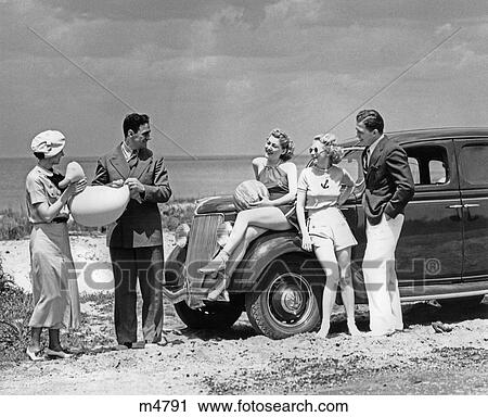 1930S Group Of Five Men & Women At 1936 Ford V-8 Parked Along Shore Playing With Inflatable Beach Toys View Large Photo Image Stock Image - 1930S Group Of Five Men & Women At 1936 Ford V-8 Parked Along Shore Playing With Inflatable Beach Toys . Fotosearch