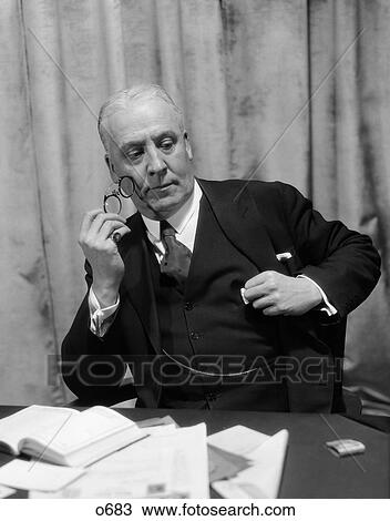 1930S Man In Suit & Tie Sitting At Desk Holding Pince-Nez With Pensive Look View Large Photo Image Stock Image - 1930S Man In Suit & Tie Sitting At Desk Holding Pince-Nez With Pensive Look . Fotosearch