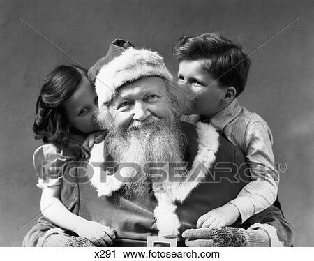 1930S Man Santa Claus Posing With Boy And Girl Hugging Him Smiling Indoor View Large Photo Image Stock Image - 1930S Man Santa Claus Posing With Boy And Girl Hugging Him Smiling Indoor . Fotosearch