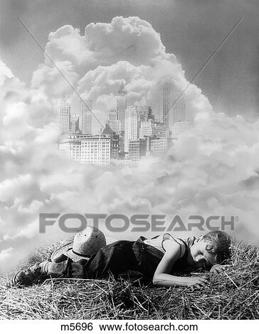 1930S Montage Of Farm Boy Asleep On Hay Dreaming Of City In Clouds View Large Photo Image Stock Photograph - 1930S Montage Of Farm Boy Asleep On Hay Dreaming Of City In Clouds . Fotosearch